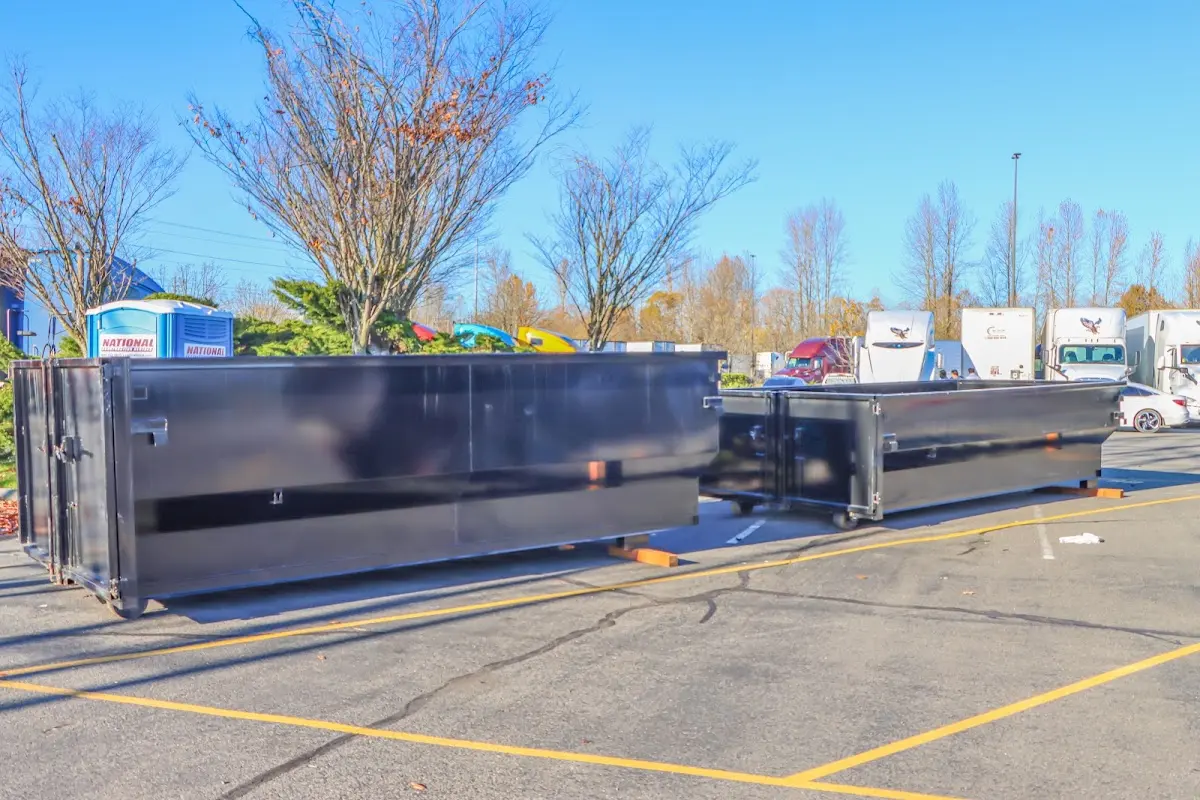 Professional dumpster rental service with roll-off container on residential driveway in Elizabethtown